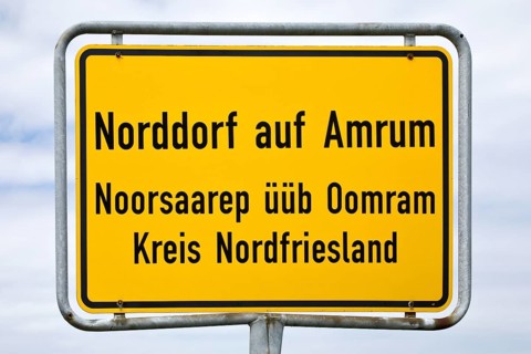 Bilingual place-name sign of Norddorf on the island Amrum in German and Frisian