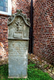 Historic sandstone gravestone from the 18th century in the churchyard of St. Nicholas Church