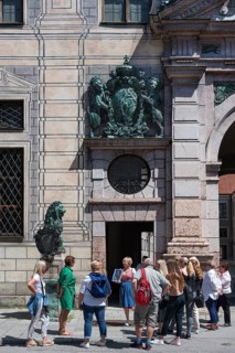 West front of the Residenz with tourist group during city tour
