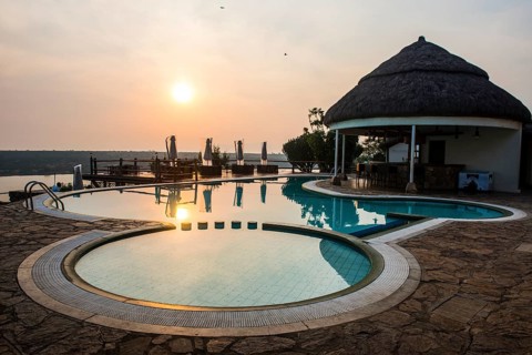 Swimming pool above the Kazinga channel linking lake george and lake Edward at sunset
