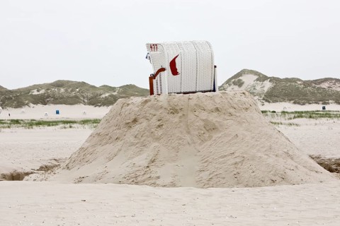 Beach chair on a built sand hill at the beach