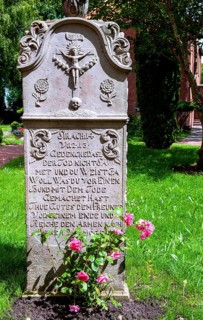 Historic sandstone gravestone from the 18th century in the churchyard of St. Nicholas Church