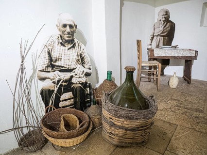Farmer weaving a basket and farmer's wife at the dining table