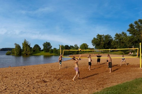 Men playing beach volleyball