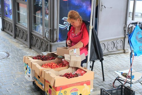 Vendor of cherries in front of Privoz food market
