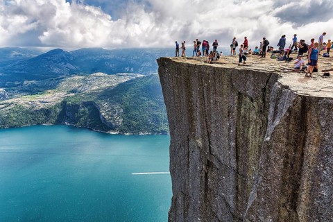 Hiker on rocky peak Preikestolen