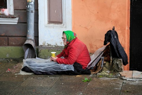 Old woman sitting on the floor