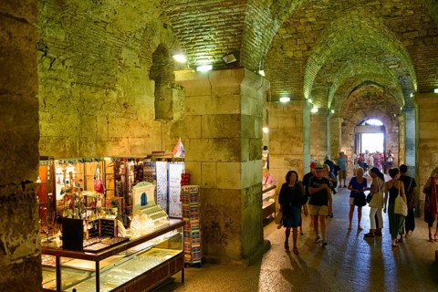 Merchants in illuminated catacombs