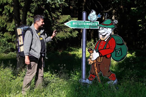 Hiker and sign Wetzsteinhuette