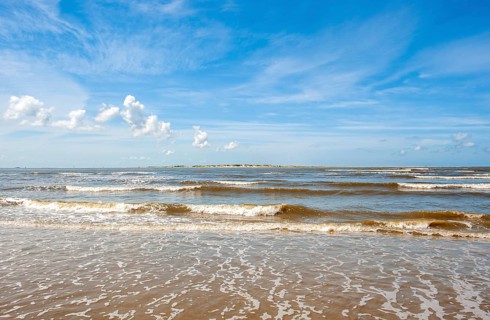 Sandy beach beach at the harbour of the island Baltrum