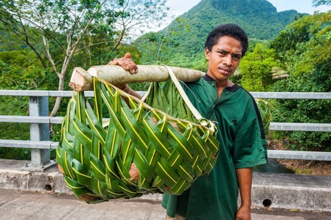 Local farmer bringing his goods in palm baskets back home