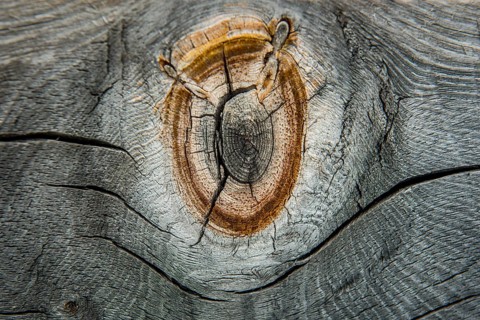 Weathered wood with knothole at an alpine hut