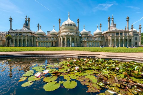 Royal Pavilion palace reflected with a pond with water lilies