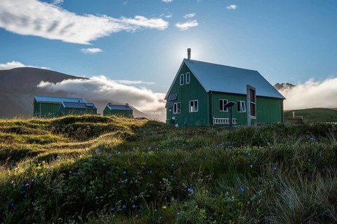 Huts of the Icelandic Hiking Club in the backlight