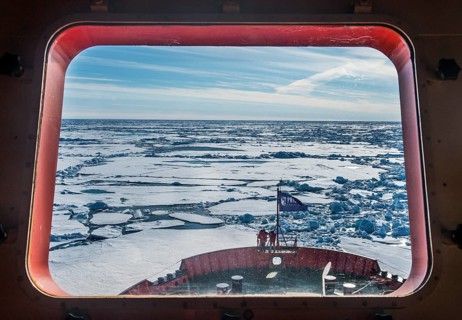 Look through a window of an icebreaker breaking the ice on its way up to the North Pole