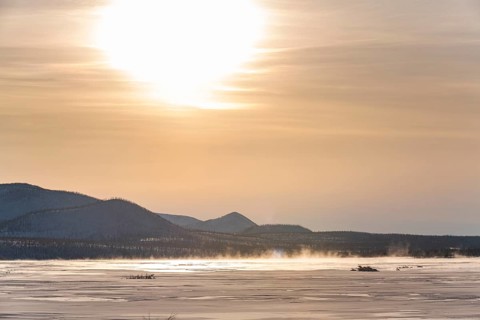 Sunset over a frozen river along the Road of Bones