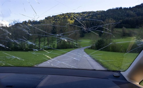 Shattered windscreen due to hailstones on a car