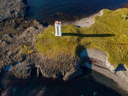 Lighthouse and coastal landscape with basalt formations
