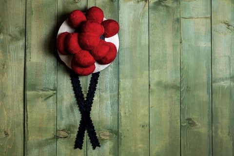Original Black Forest Bollen hat in front of green wooden wall