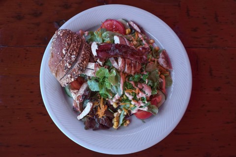 Salad with roasted turkey strips served in a garden restaurant