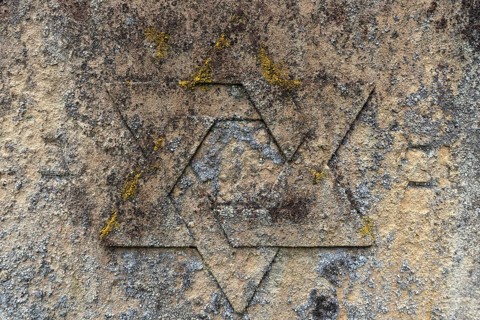 Weathered Star of David on a gravestone