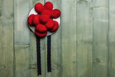 Original Black Forest Bollen hat in front of green wooden wall