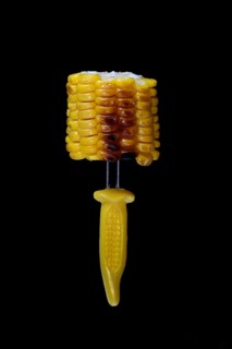Grilled corn on the corn cob on a corn on the cob holder