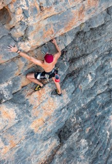 Climber climbing on a rock face