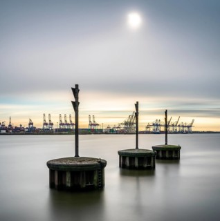 Long exposure of concrete bollards in the river Elbe at the port of Hamburg