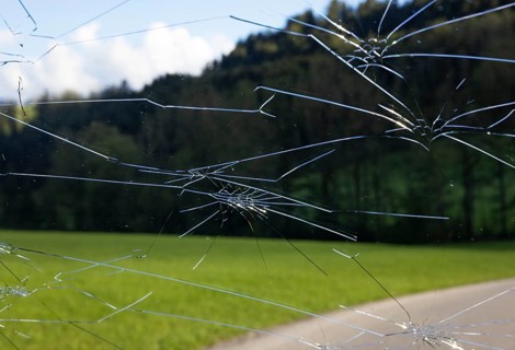 Shattered windscreen due to hailstones on a car