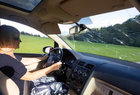 Shattered windscreen due to hailstones on a car