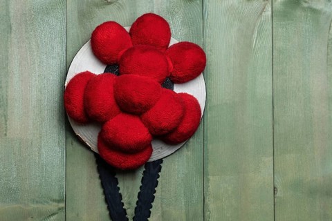 Original Black Forest Bollen hat in front of green wooden wall