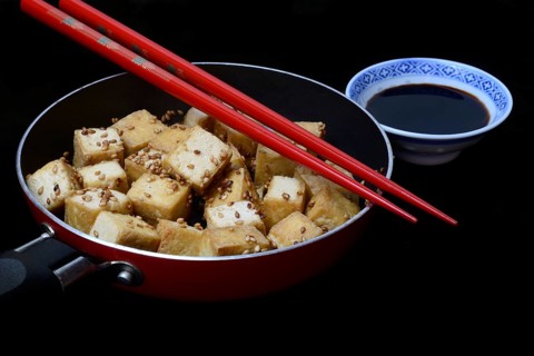 Fried tofu cubes in pan