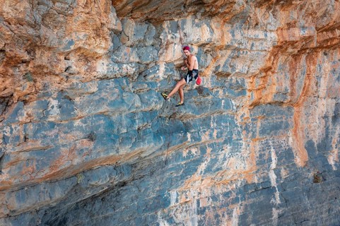 Climber climbing on a rock face