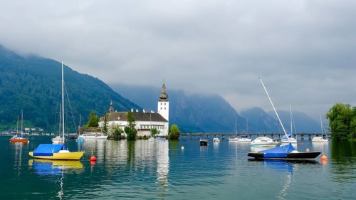 Orth Castle on Lake Traun in Gmunden and boats in the water