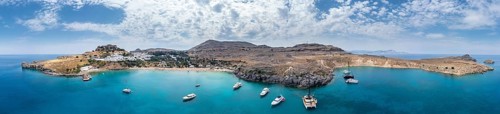 Sailboats anchoring in front of Lindos