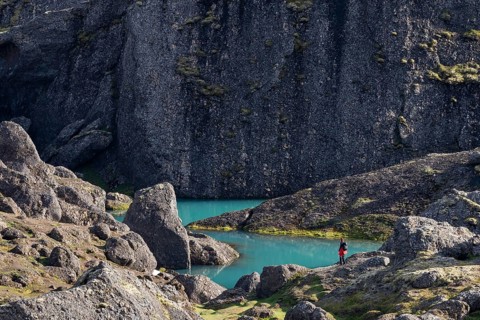 Woman standing in front of turquoise water pool