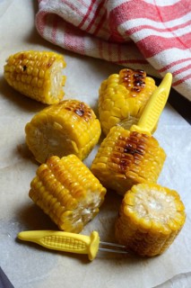 Roasted corn on the corn cob with corn on the cob holder