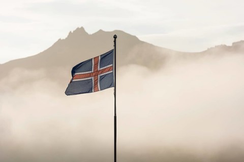 Cabins of the Icelandic Hiking Association in front of the mountain range Dyrfjoell