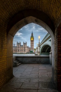 View through archway onto Westminster Bridge with Thames and Palace of Westminster