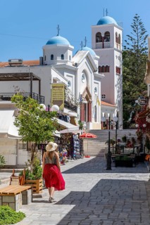 Young woman with dress walking through pedestrian zone