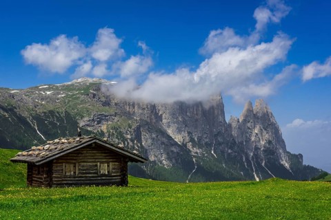 Alpine huts in front of the Schlern massif
