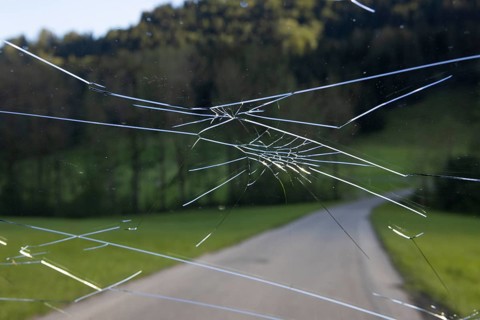 Shattered windscreen due to hailstones on a car