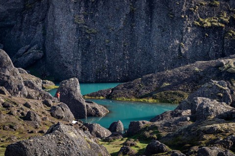 Man standing at turquoise water pool