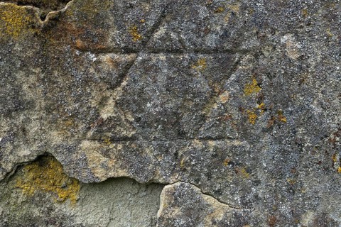 Weathered Star of David on a gravestone