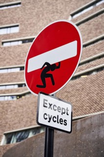 One-way street sign with street art manikin