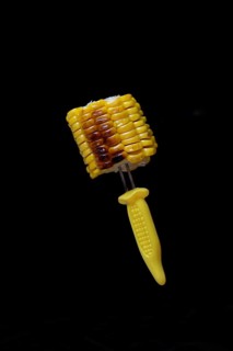 Grilled corn on the corn cob on a corn on the cob holder