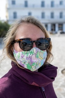 Young woman on vacation with mouth to nose covering