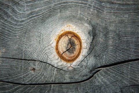 Weathered wood with knothole at an alpine hut