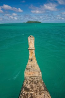 Traditional wood carved boat in the Aitutaki lagoon